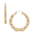JE316_main "A pair of gold hoop earrings displayed on a card. The earrings have a textured design that resembles bamboo, giving them a unique and stylish appearance. The card indicates that the earrings are lead and nickel free, and it is labeled with the