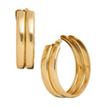 JE535_main "A pair of gold hoop earrings. The earrings have a polished, shiny finish and a double-hoop design, giving them a layered appearance. One earring is shown from the front, displaying its circular shape, while the other is shown from the side, hi