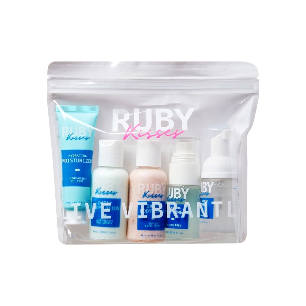 RHSTK01_main "A skincare travel set from the brand "Ruby Kisses." The set is packaged in a clear plastic bag with a resealable zipper. The bag contains several small bottles and tubes of skincare products, including a hydrating moisturizer, a cleanser, an