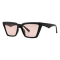 SUN09V5_main "A pair of stylish sunglasses with a bold, angular design. The frames are predominantly black, showcasing a distinctive cat-eye shape that adds a modern flair. The lenses are tinted in a soft pink hue, providing a chic contrast to the dark fr
