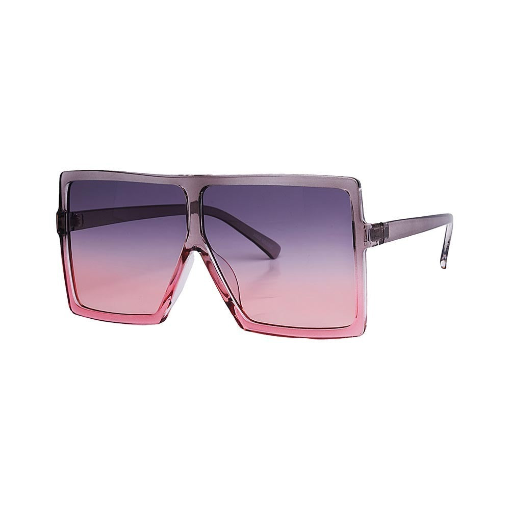 SUN15V2_main "A pair of stylish sunglasses with a modern, oversized square frame design. The frame is transparent with a gradient effect, transitioning from a darker shade at the top to a lighter, pinkish hue at the bottom. The lenses also have a gradient