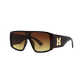 SUN33V6_main "A pair of oversized sunglasses with a bold, rectangular frame. The lenses have a gradient tint, transitioning from a darker brown at the top to a lighter shade at the bottom. The frame appears to be a rich, dark brown color, complementing th