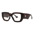 SUN43V5_main "A pair of stylish eyeglasses with a bold, geometric design. The frame is predominantly in a tortoiseshell pattern, showcasing rich brown and amber tones. The lenses are clear, and the overall shape is angular, giving the glasses a modern and